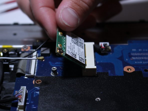 Now grab the Wi-Fi card and slowly pull it up and outward as shown in the photos.