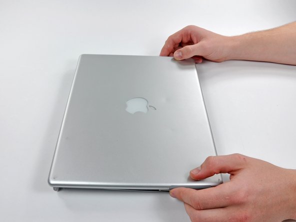 Image 1/3: Slide the rear display bezel away from you to undo the last few clips.