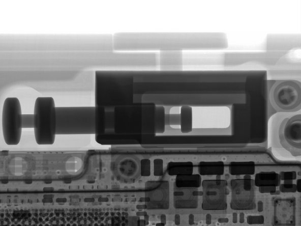 The slider button moves a hefty metal plunger, which flips a mechanical switch soldered to the motherboard. The X-ray image provides an even better view.