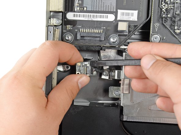 Image 3/3: Use the flat end of a spudger to pull the Bluetooth data cable out of its connector and remove the Bluetooth board.