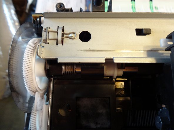Slide the print head left until it is at the end of the rail. You can feel it release (lift upwards when it aligns with the cut out notch)