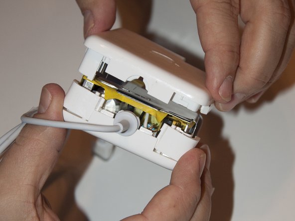 Image 1/3: Hold the flaps in place and install the other half of the casing.