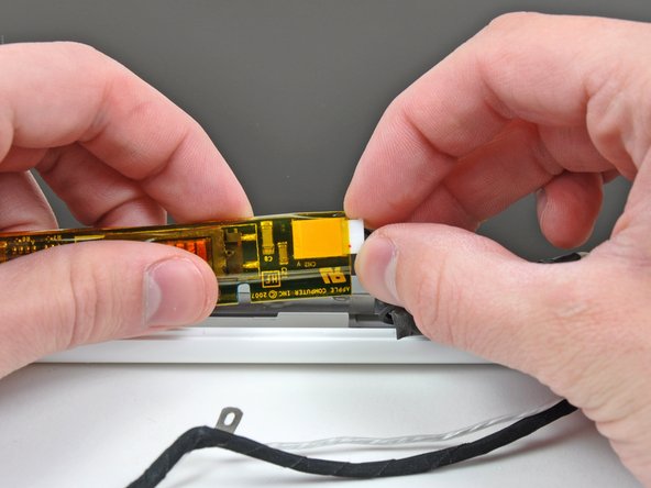 Lift the inverter out of the display slightly and disconnect the backlight cable from its right side.