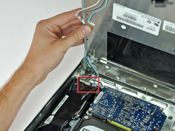 Image 1/1: Disconnect the remaining two inverter cables (shown in red) by pulling their connectors toward the top edge of your iMac.