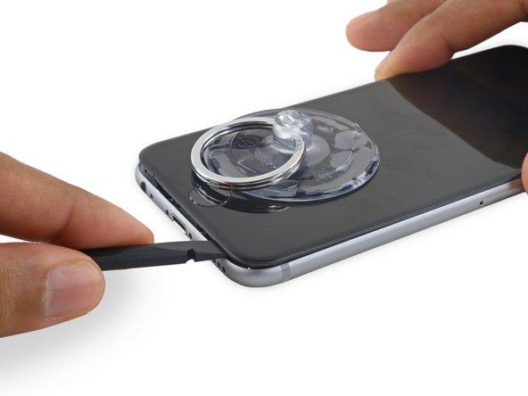 Slide the spudger to the right, along the bottom edge of the phone.