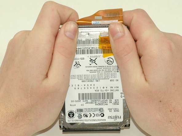 Image 1/1: This is a bit tricky. Try holding the drive against your body while pushing the cable away from you, or rocking the cable gently from side to side while applying even pressure, or both. If you bend the pins, do your best to straighten them, using the hard drive cable as a guide.