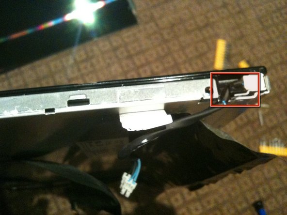 Image 3/3: Un-clip the CCFL cable from the black plastic surround