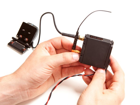 Image 1/2: To begin tearing the device apart, we detached the two antennas from their screw-in mounts on the transmitter/receiver module.