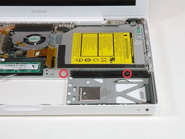 Remove the two Phillips screws from the front edge of the optical drive.