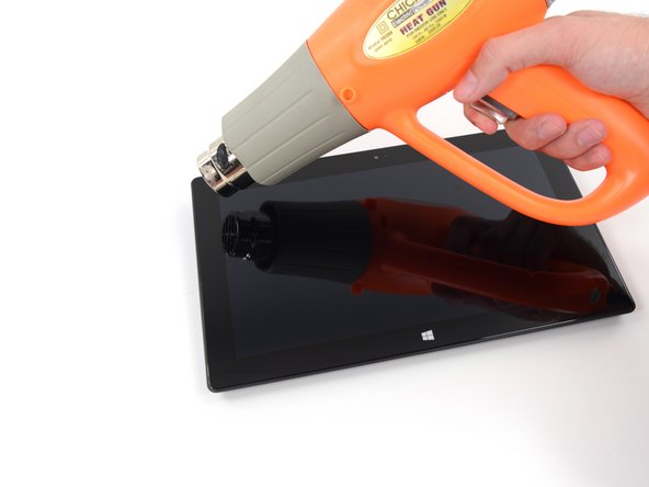 Image 1/3: Time to poke a [http://www.youtube.com/watch?v=tyBUMntP6DI&t=22s|plethora|new_window=true] of picks under the now-molten adhesive. The use of oodles of dainty picks over brute force ensures our ribbon cables' protection.