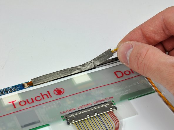 Image 2/2: Carefully peel the camera cable off the foam tape along the top edge of the LCD.