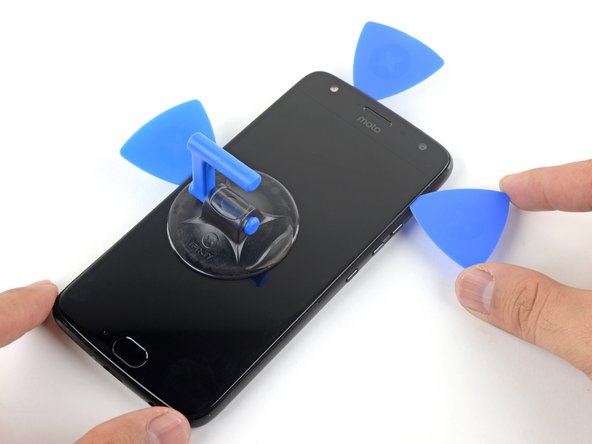 Use an opening pick to slice along the right edge to separate the adhesive.