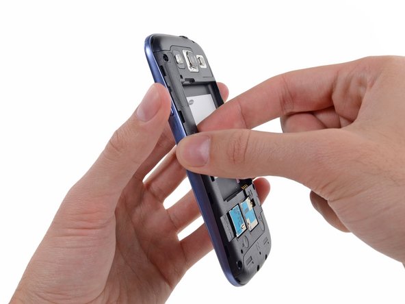 Image 1/2: Grasp the left side of the plastic midframe with your thumb and forefinger and lift it away from the phone.