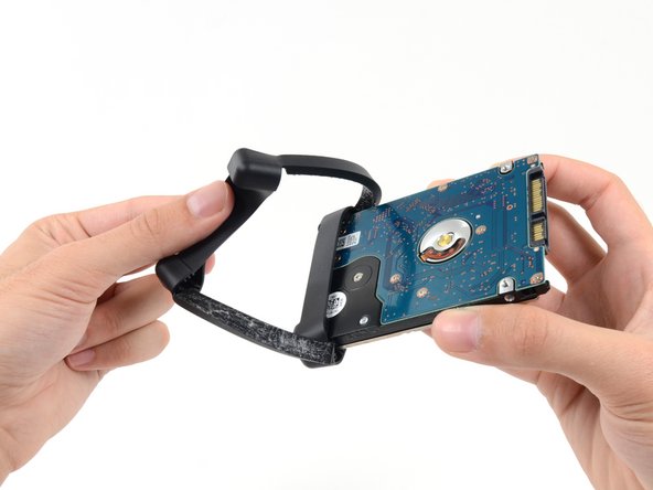 Image 1/2: Remove the sleeve from the hard drive.