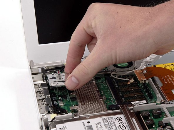 Lift the modem and modem shield from the bottom.