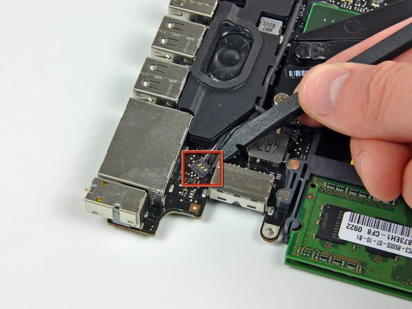 Image 1/2: Deroute the microphone cable from the channel in the left speaker.