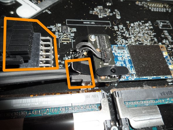 Image 3/3: At last you'll disconnect the main power cord and the Hard Drive SATA cable. I photographed the top one already disconnected; be sure to squeeze the edge tabs to release the clamp hooks. The HDD SATA connector has a convenient pull tab.