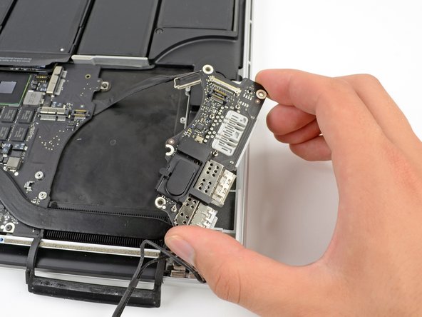 Image 2/2: Carefully lift the I/O board and remove it from the lower case.