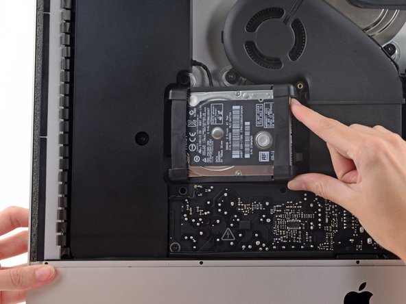 Image 2/3: The hard drive is attached by a single SATA power/data cable, do not attempt to fully remove it from the iMac.