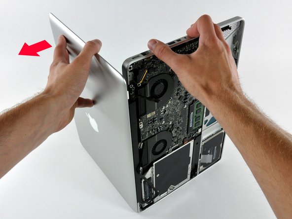 Image 2/3: Lift the display away from the upper case, minding any brackets or cables that may get caught.