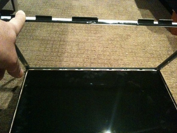 Image 2/3: Make sure you are careful when removing the bezel from the TOP edge as you will be exposing the 8 flex cables mentioned in step 1.