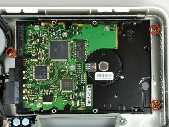Image 1/2: Lift the hard drive from its right edge and maneuver it out of the midplane.