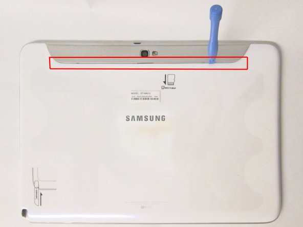 Image 2/3: Use the plastic opening tools to pry along the indicated box.