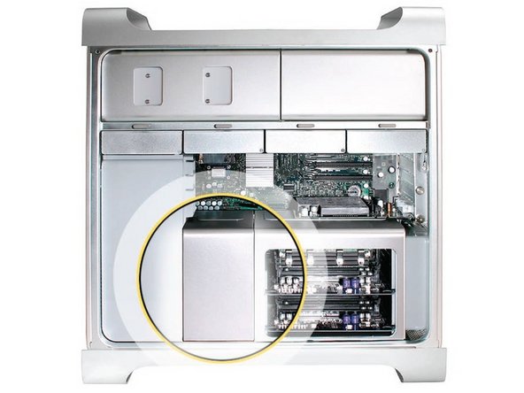 Image 1/3: Place the fingers of one hand under the lip of the heatsink cover nearest the logic board. Lift the lip slightly toward the media shelf to release the tabs and magnets under the top face of the cover