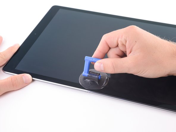 While holding down the corners of the device, repeatedly pull up on the display then ease it back down to weaken the adhesive.