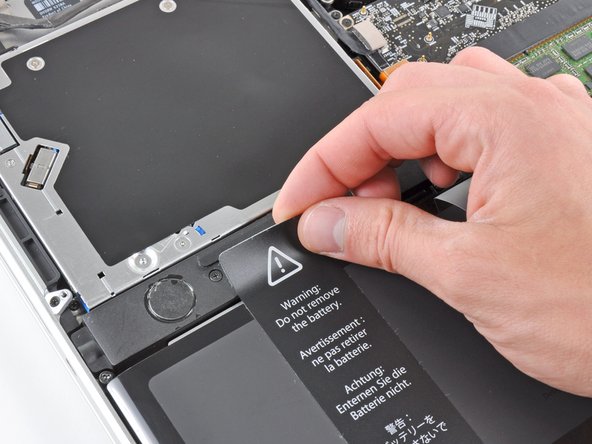 Image 2/2: It is not necessary to completely peel the sticker off the battery.