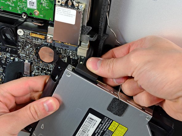 Image 1/1: Remove the optical drive from the iMac.