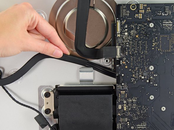 Image 3/3: In a similar fashion, lift the combo SATA data/power cable up out of the retaining clip.