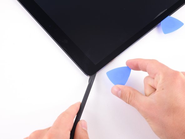 Insert a pick in the upper left corner of the iPad.