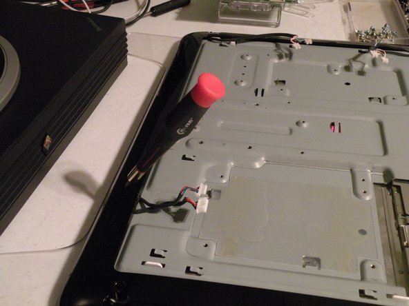 Image 2/3: This will reveal numerous phillips screws.