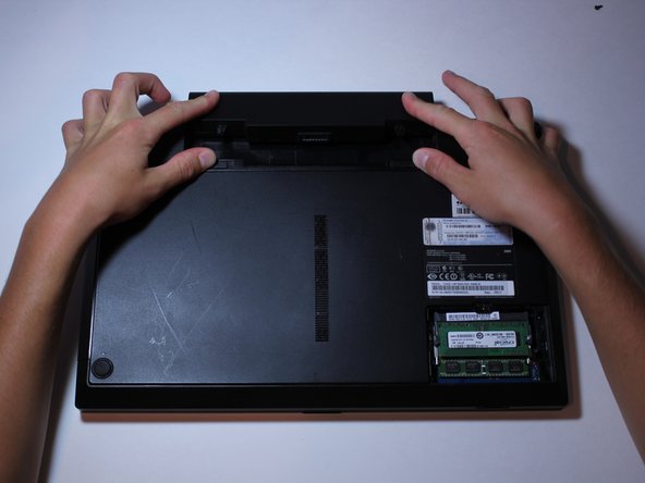 While doing this, slide the battery out.