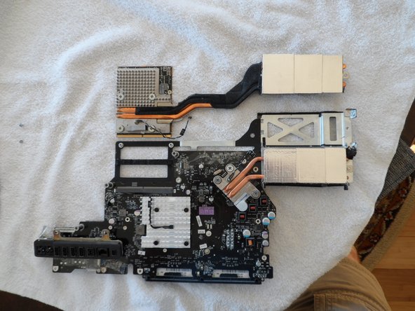 Image 1/3: In the second photo you can see the replacement graphics card (Apple part #661-5135) I got from Impact Computers in Florida. It's a drop-in replacement. Even the adhesive foam and thermal sensor are already in place. In fact, you better not turn your back or you may forget which is which!