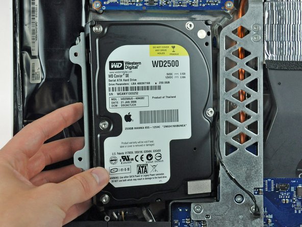 Image 1/1: When reinstalling your hard drive, make sure not to push the rubber grommets through the chassis with the hard drive mounting pins as retrieving them may require removing the logic board.