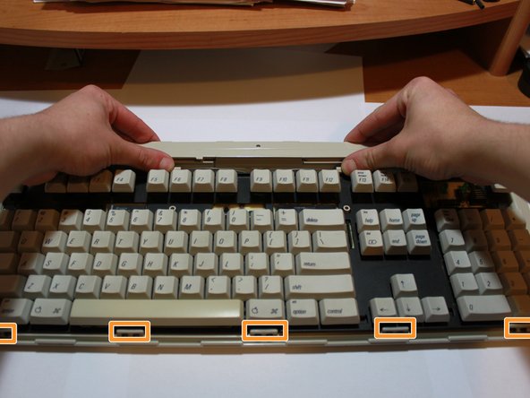 Image 2/3: Lift the entire PCB assembly up and away from the keyboard case.