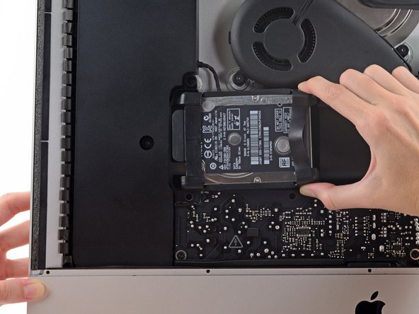 Image 3/3: The hard drive is attached by a single SATA power/data cable, do not attempt to fully remove it from the iMac.