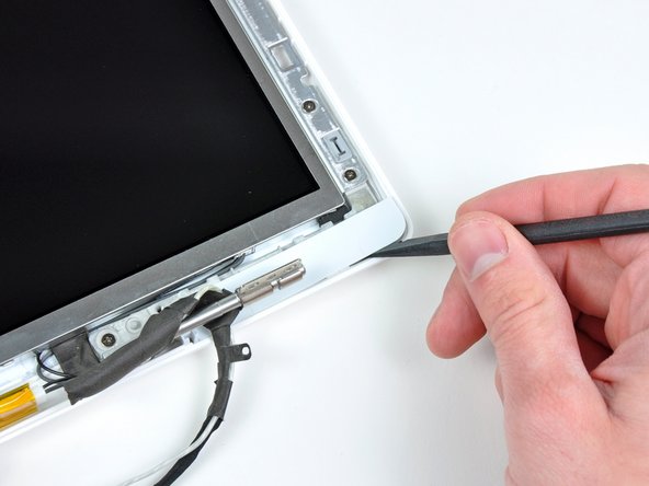 Use a spudger to slide the right bezel cover toward the LCD panel.