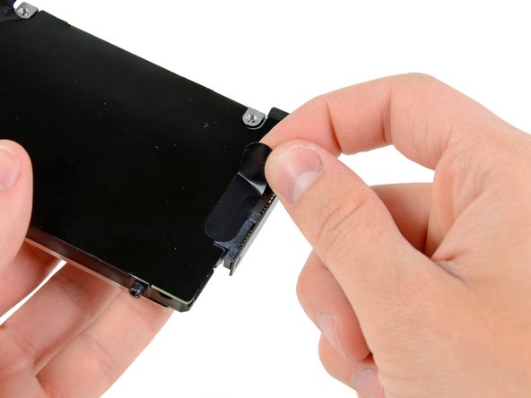 Image 1/2: Remove the hard drive cable by pulling its connector straight away from the hard drive.