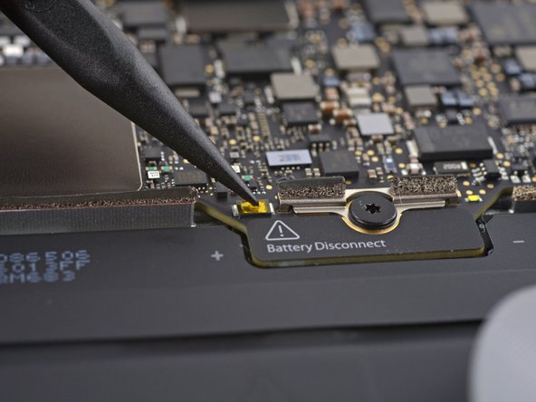 Image 2/3: We've seen something like this before—in the iPad, Apple loves to hide the battery connector under the logic board. This is the first time we've seen it in a laptop, so it looks like it's time for...
