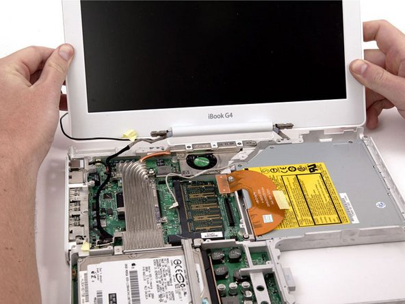 Tilt the display back, freeing it from the two metal alignment posts holding the hinges in place, and slide it away from you.