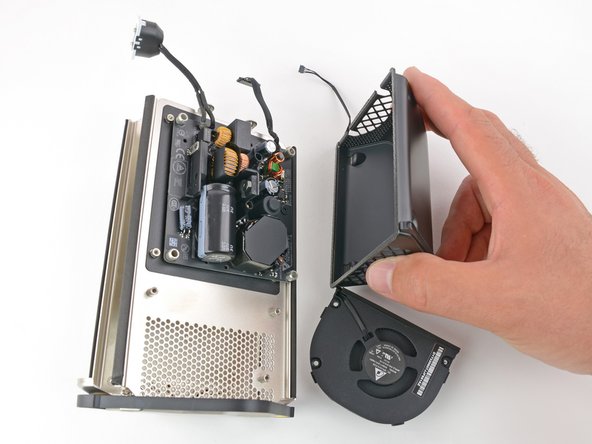 Image 3/3: We quickly blow off the fan in favor of peeking under the metal casing.