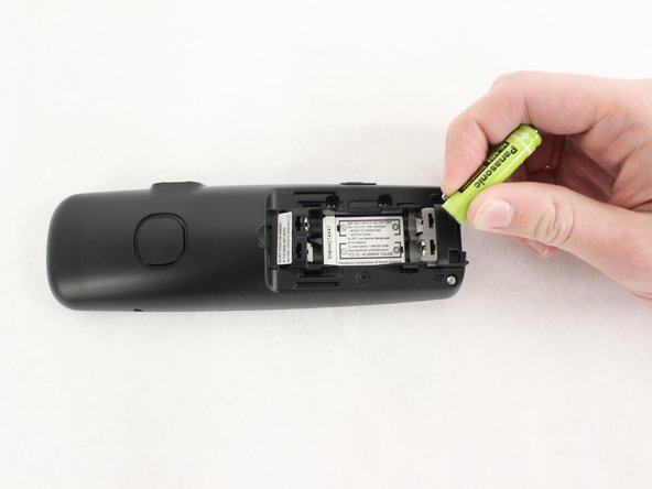 Carefully remove the two batteries by lifting up from one end.