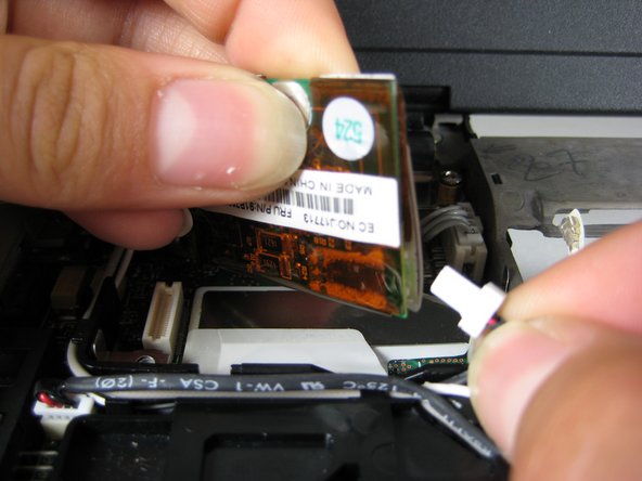 Image 2/2: Unplug the other cable that attaches the modem to the motherboard