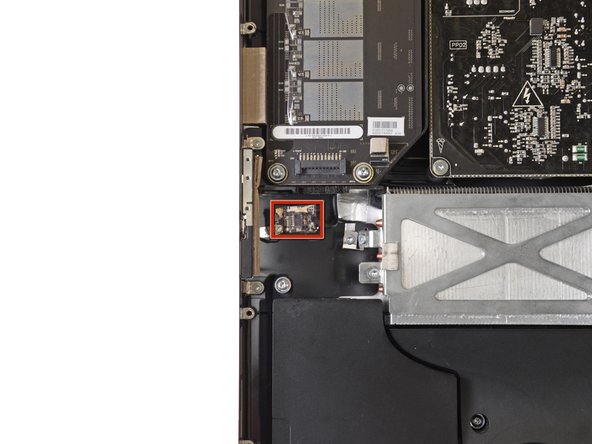 Image 1/2: Use the flat end of a spudger to gently pry the antenna cable off of its socket.