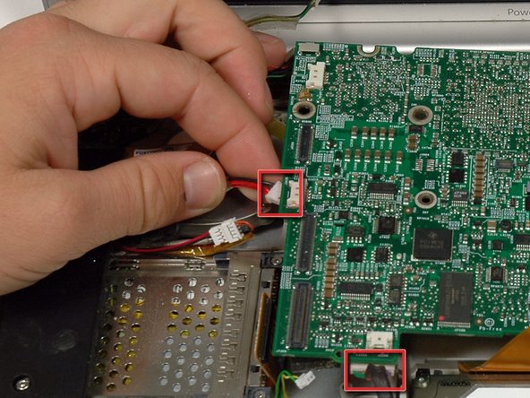 Image 1/1: While the logic board is lifted, also disconnect the battery connector.