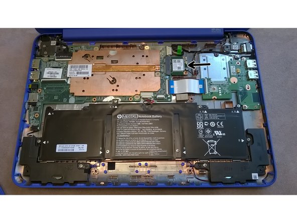 The  WiFi/Bluetooth mPCIe card is located to the right of the  motherboard, highlighted with the arrow.
