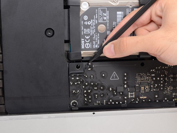 Image 1/3: Use the tip of a spudger to push each side of the power button cable connector and gently ''walk'' it out of its socket.